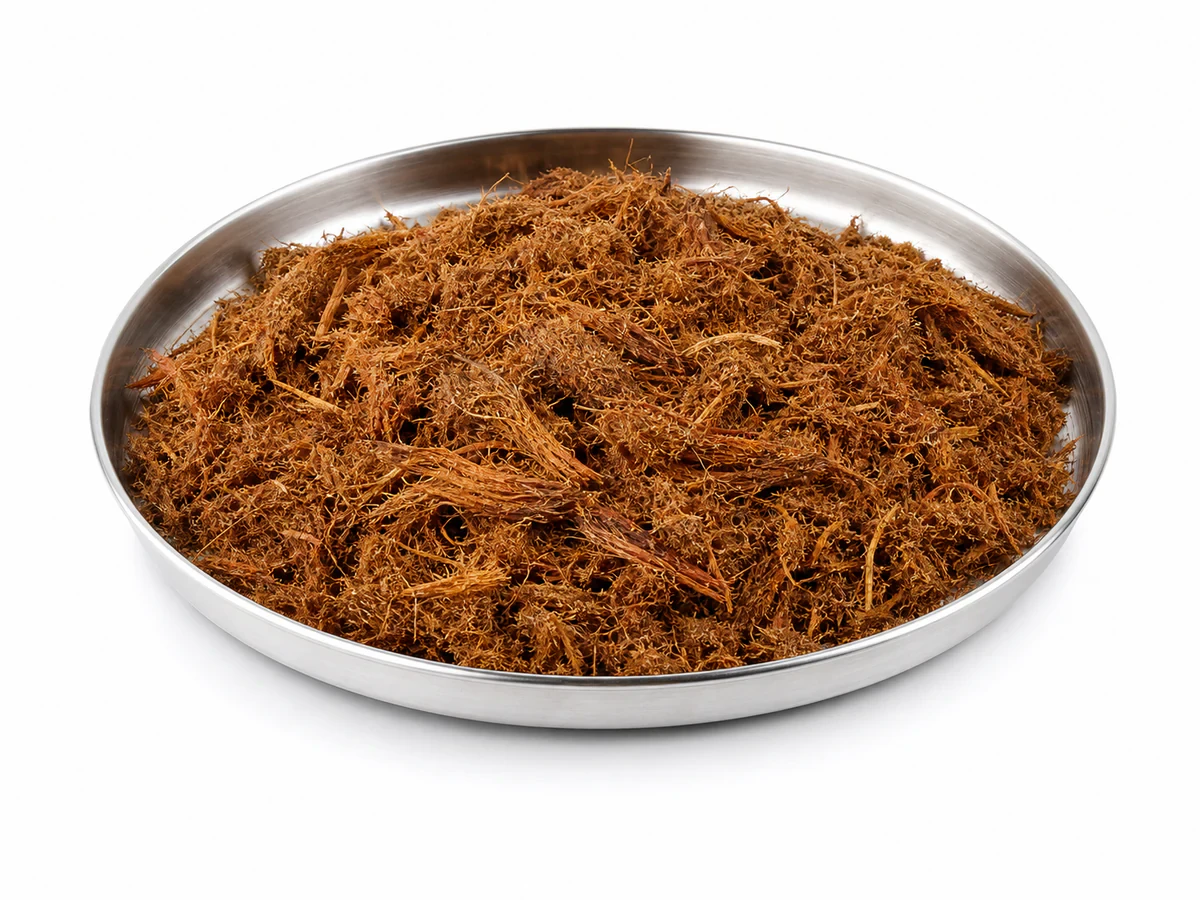 Loose reddish-brown mesocarp press fibre strands from a palm oil mill