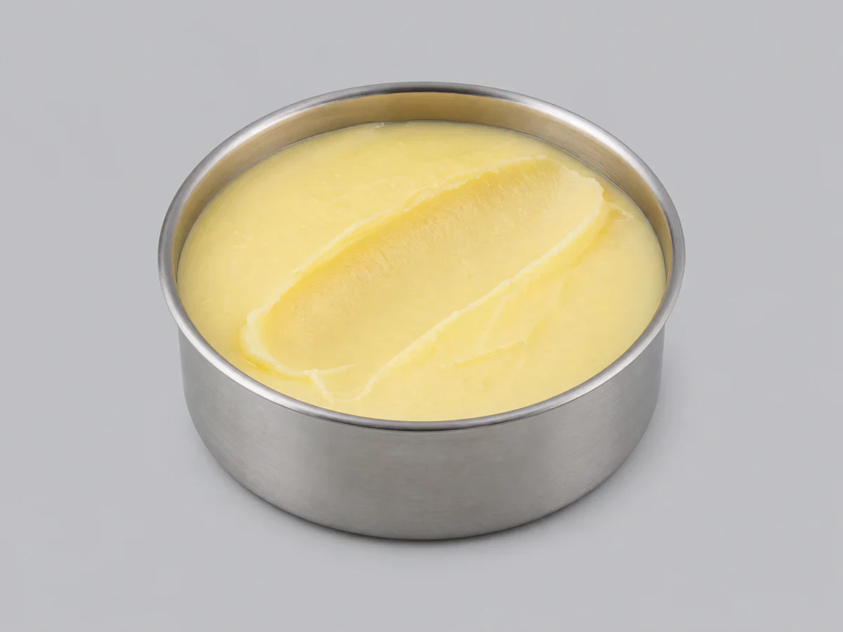 Pale yellow semi-solid RBD palm oil in a container at room temperature