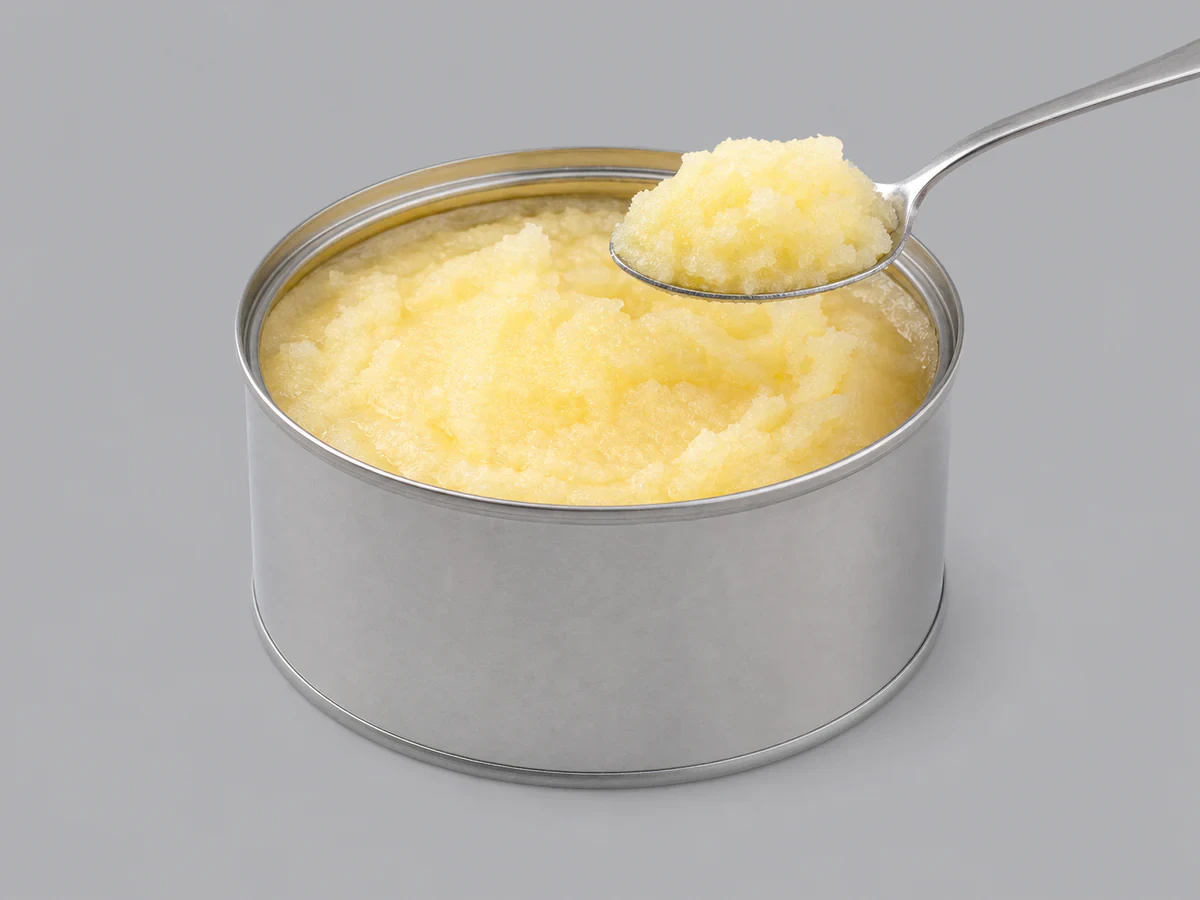 Tin of pale-yellow granular vegetable ghee (vanaspati)